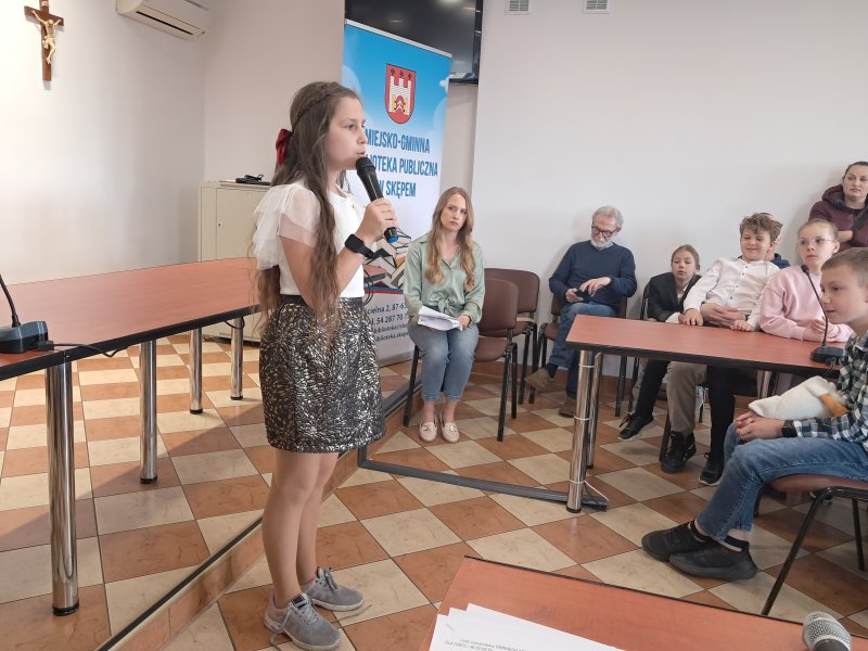 Zdjęcie przedstawia uczestniczkę konkursu w trakcie recytacji.  