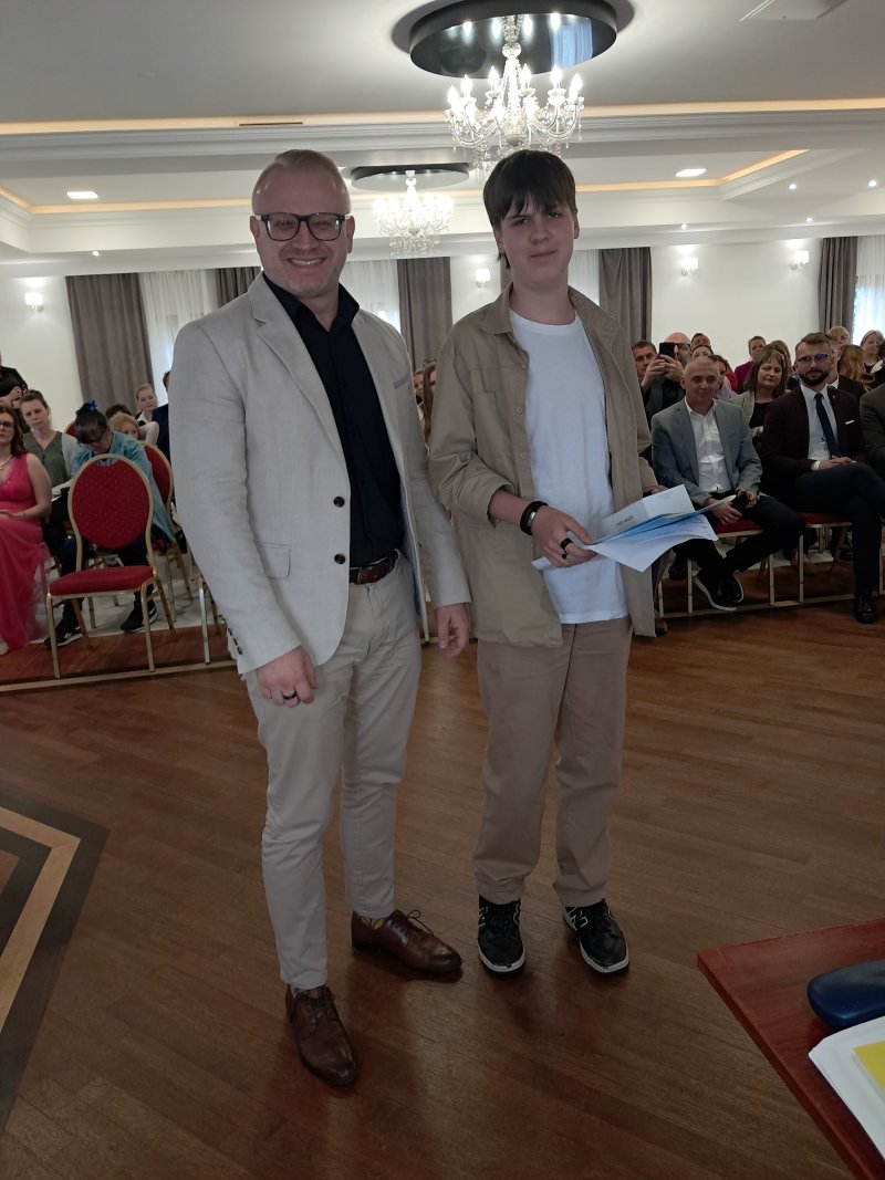 Zdjęcie przedstawia fundatora i laureata konkursu w trakcie wręczenia nagrody  