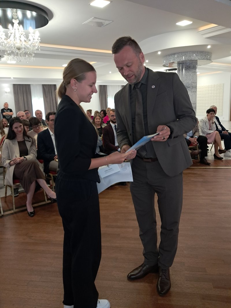 Zdjęcie przedstawia Burmistrza Skępego wręczającego nagrodę laureatowi  
